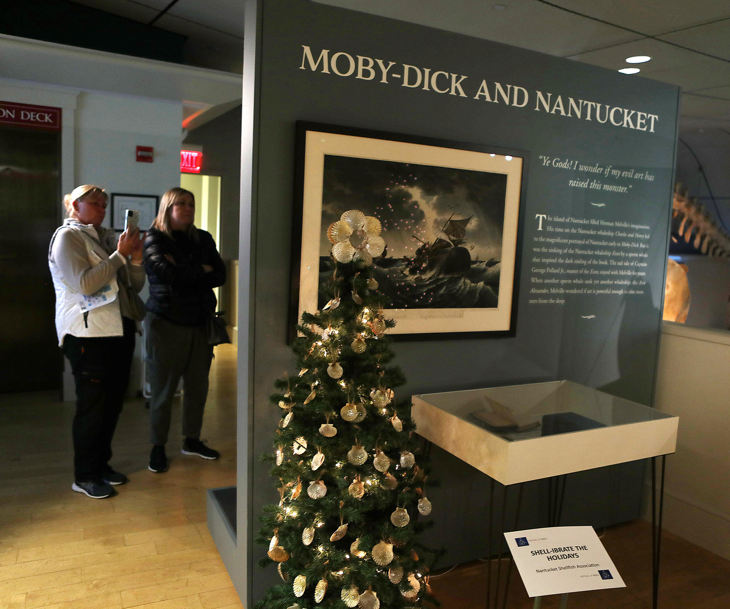 Nantucket Shellfish Association's "Shell-Ibrate The Holidays" as visitors look at another tree. Nantucket Historical Association Festival of Trees at the Whaling Museum.