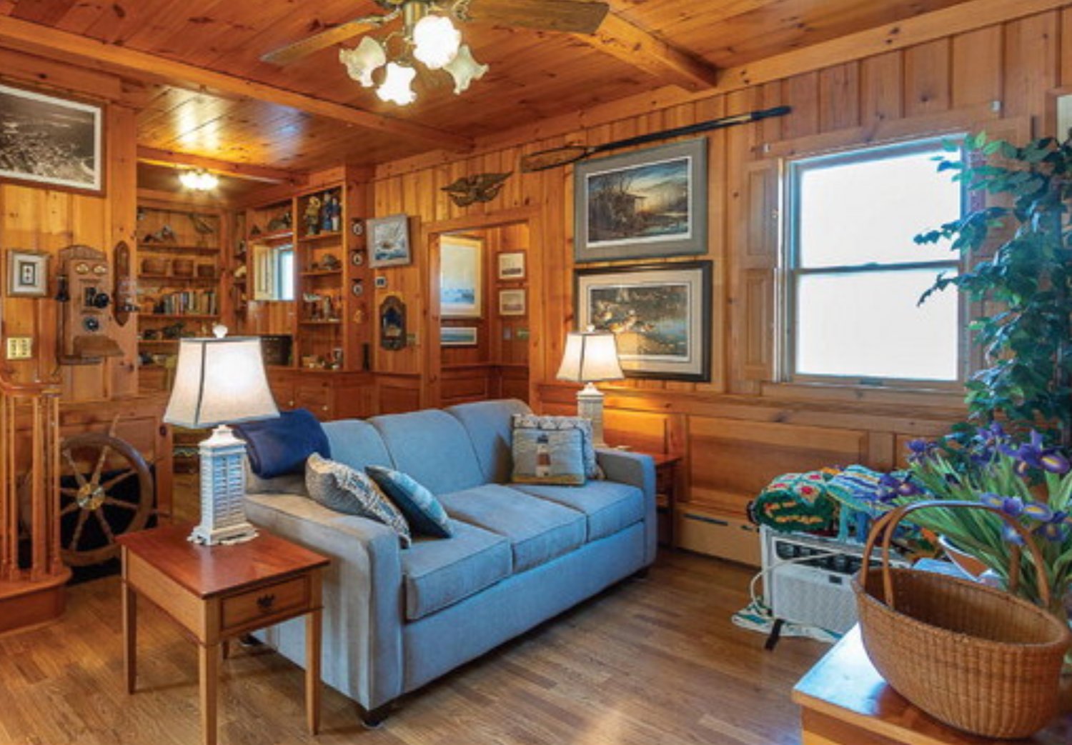 The wood-paneled first-floor family room has an exposed-beam ceiling.