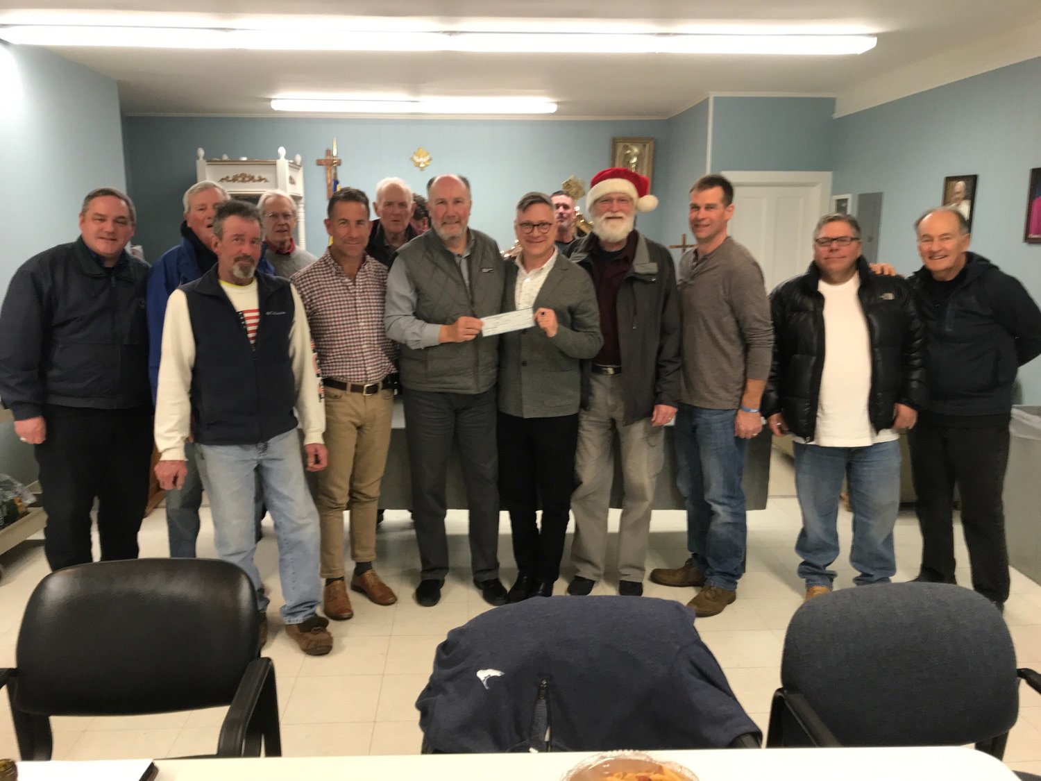Vincent DeBaggis of the Knights of Columbus T.J. McGee Council presents a check for $17,000 to Inky Santa Toy Drive board member Kenny Hilbig.