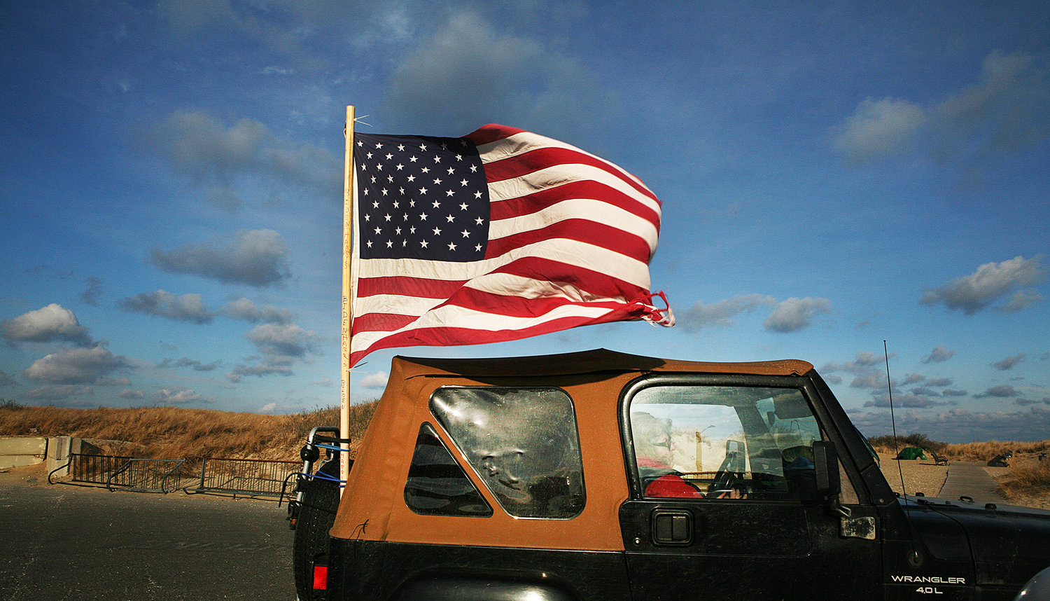 A Jeep Wrangler is decorated with an American flag as vehicles lined up at Jetties Beach for the Inauguration Day parade on Jan. 20.