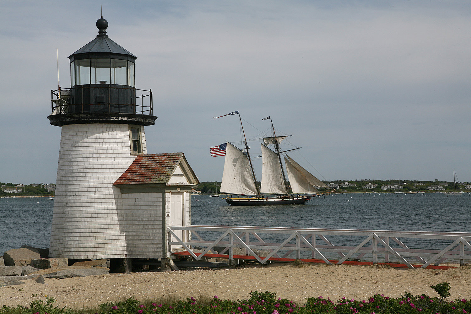 Brant Point lighthouse greets the tall ship Lynx as she returns to Nantucket in June.