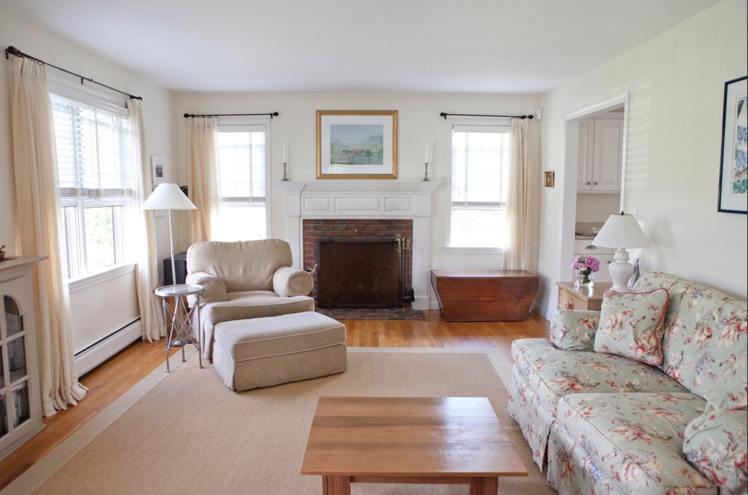 The first floor has a spacious, bright living room with a brick fireplace.