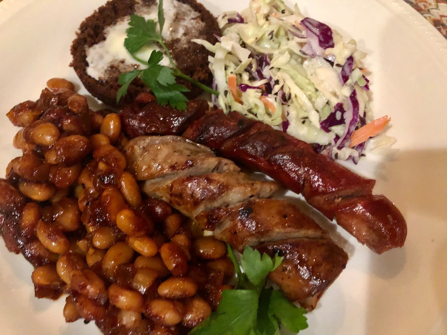 There’s no better way to take the chill off a cold winter day than with a plate of bourbon baked beans with grilled and spiralized sausages and hot dogs, with a side of cole slaw.