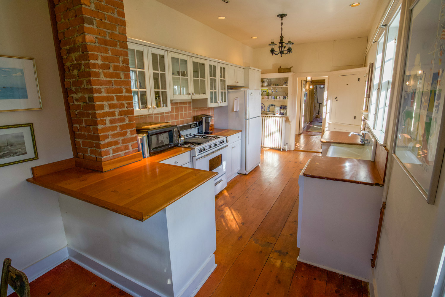 The kitchen of this Orange Street row house has wood floors, wood-topped counters and glass-front cabinets with plenty of storage space.