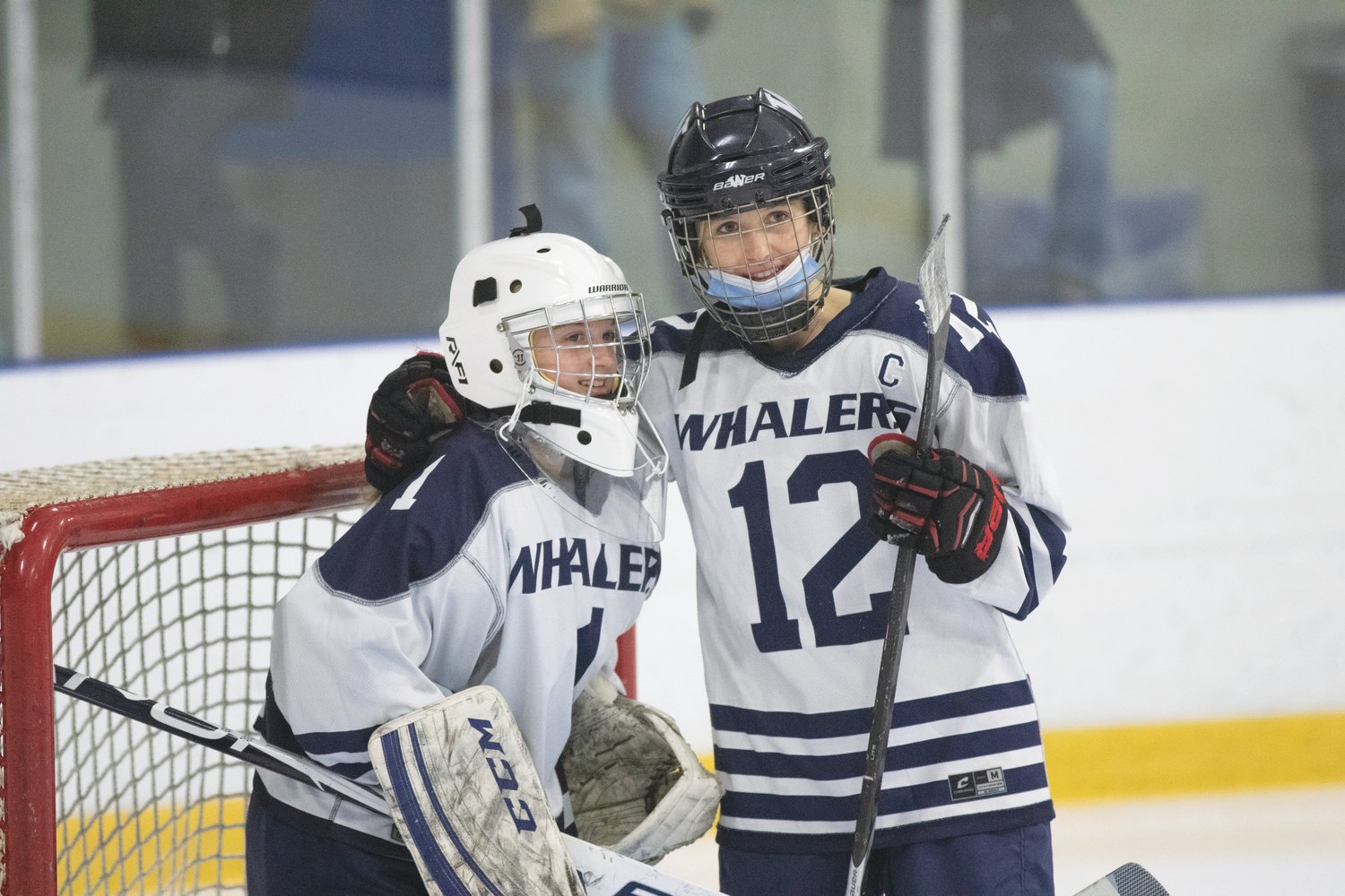 Evelyn Fey and goalie Caroline Allen share a moment Saturday.