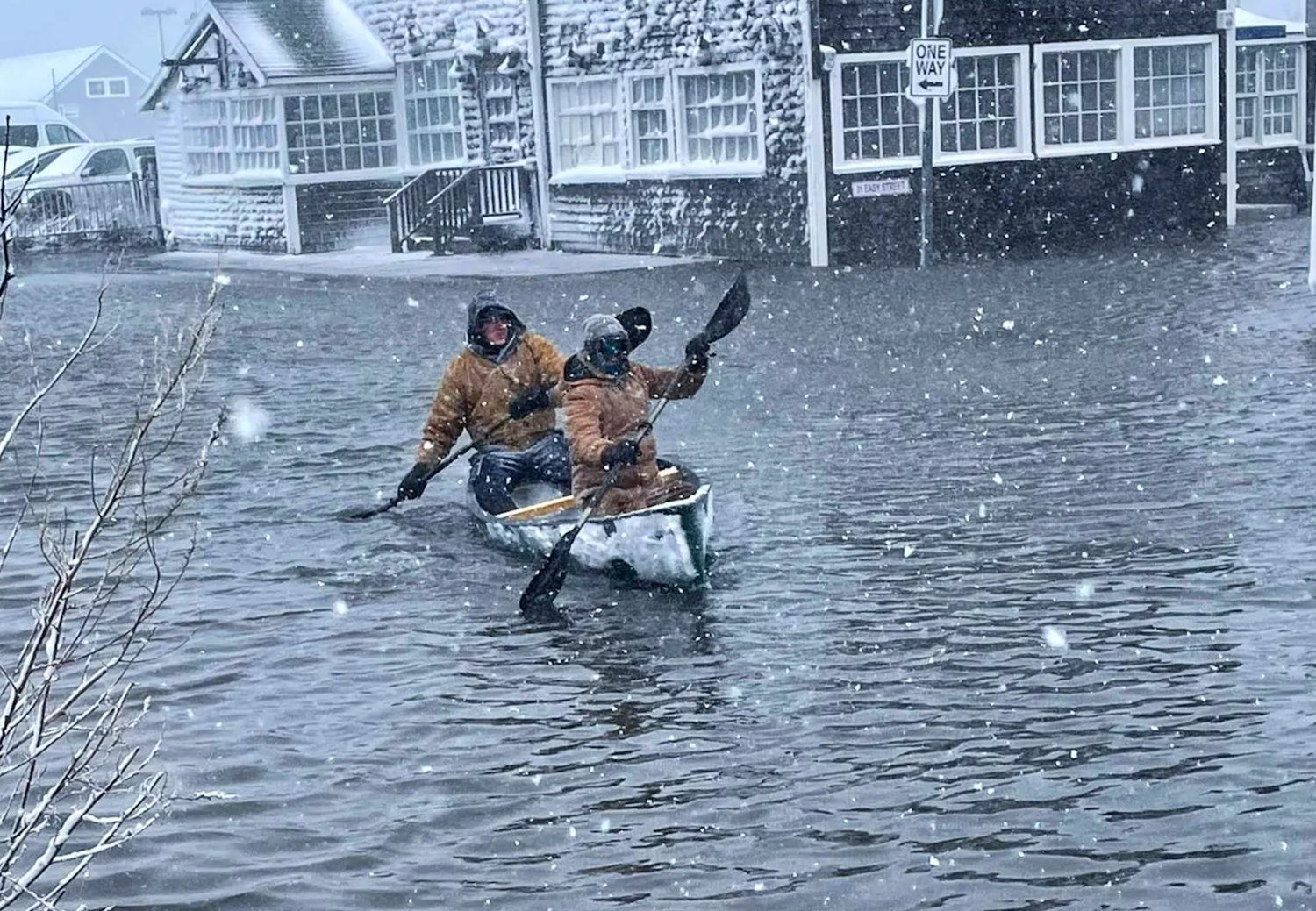 Ian Williams and Luke Stringer canoe up a flooded Broad Street during Saturday’s nor’easter.