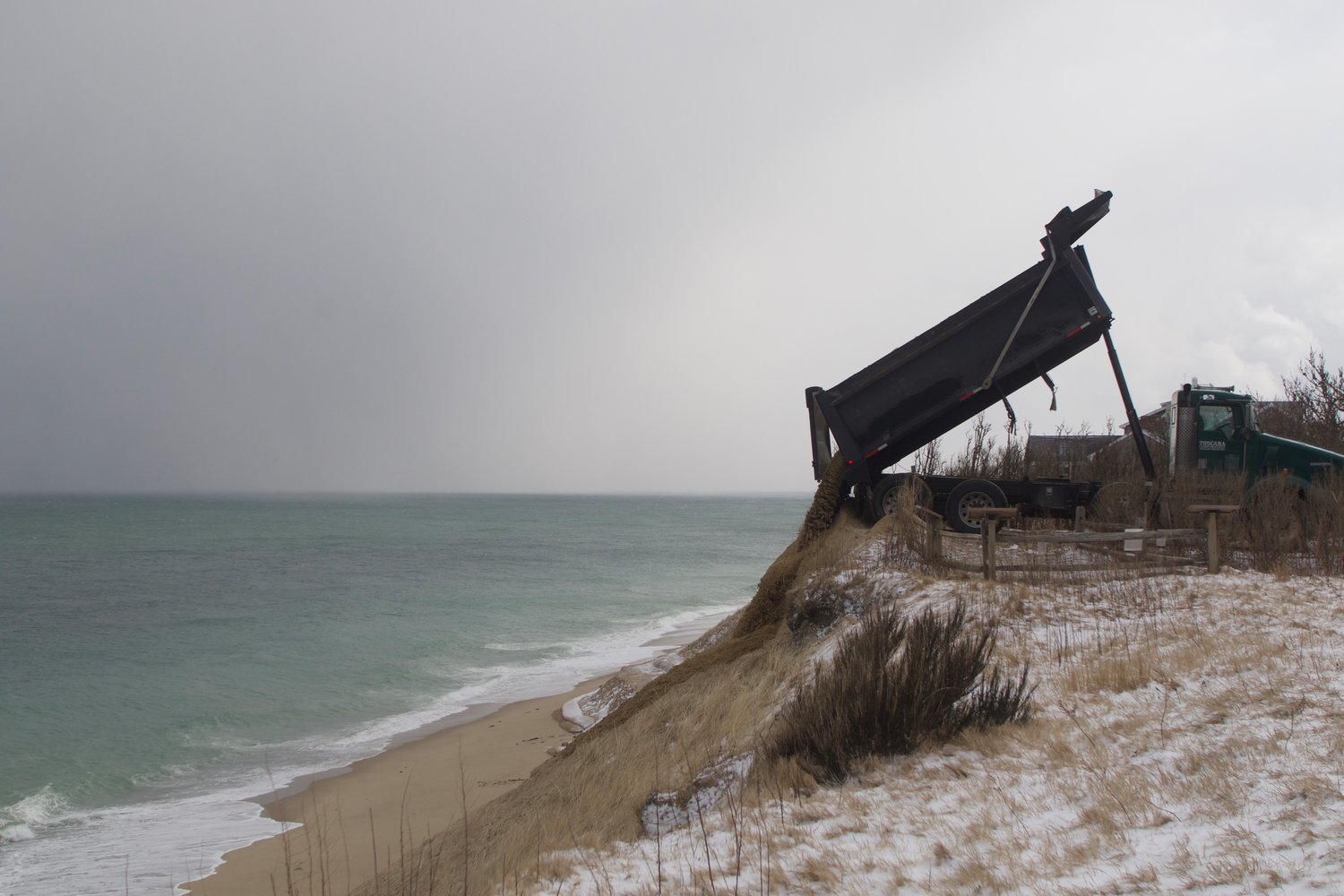 A Toscana truck pouring sand on top of the Sconset Beach Preservation Fund's erosion-control project earlier this year.