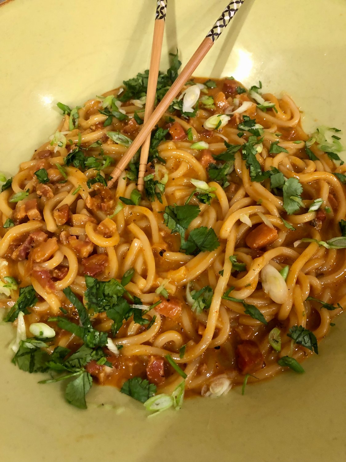 A tangle of Japanese Udon noodles is fragrant with spicy red chile gochujang paste, a common ingredient in South Korean cooking, available at Bartlett's.