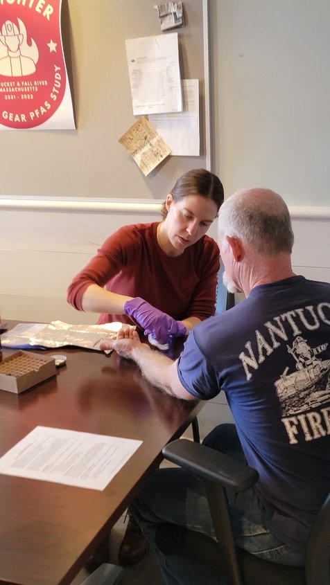 Dr. Courtney Carignan takes skin samples from firefighters after wearing turnout gear.