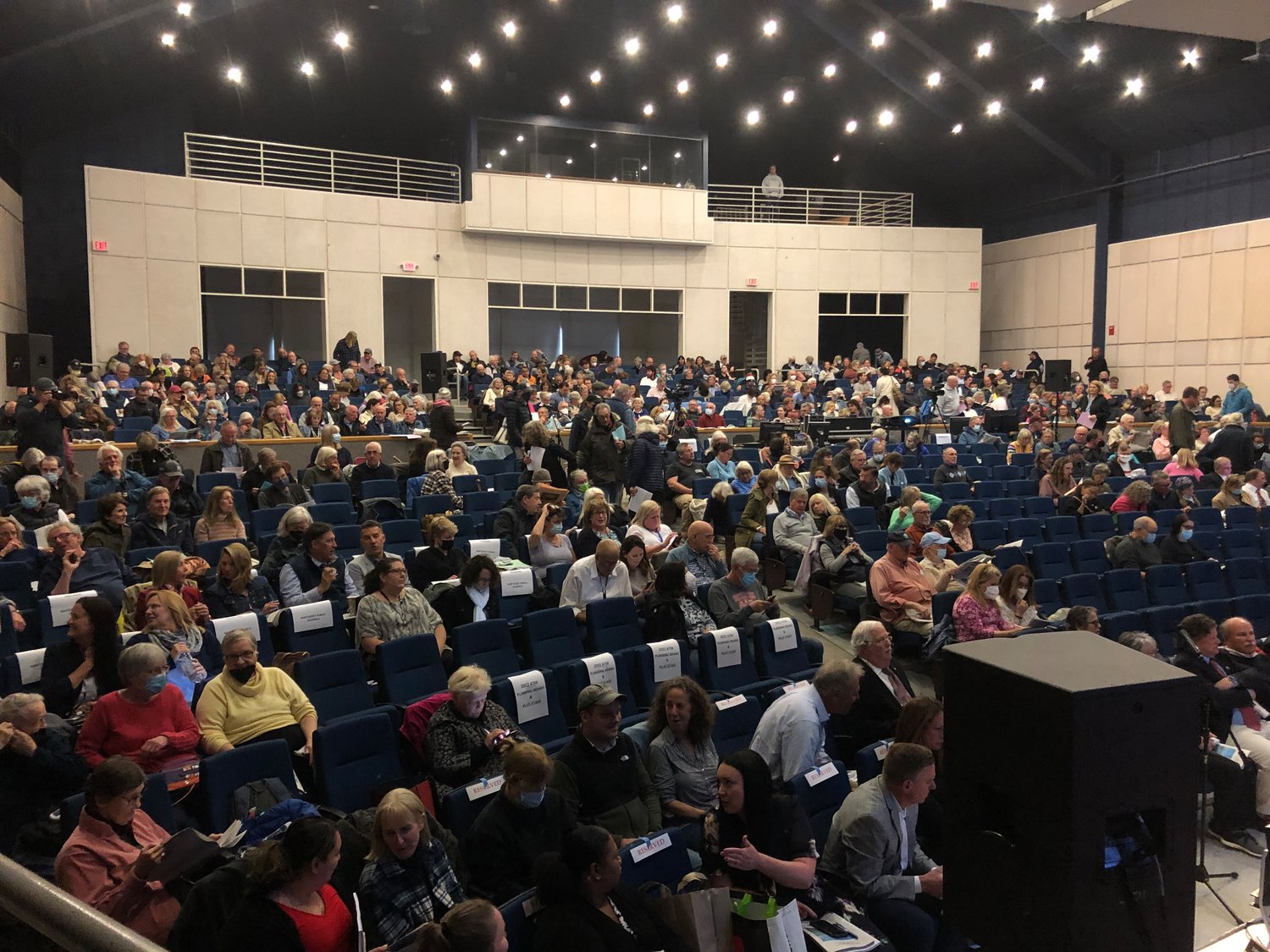 Voters continue to trickle into the Nantucket High School auditorium Monday night as the Annual Town Meeting is gaveled to order with 558 voters present.
