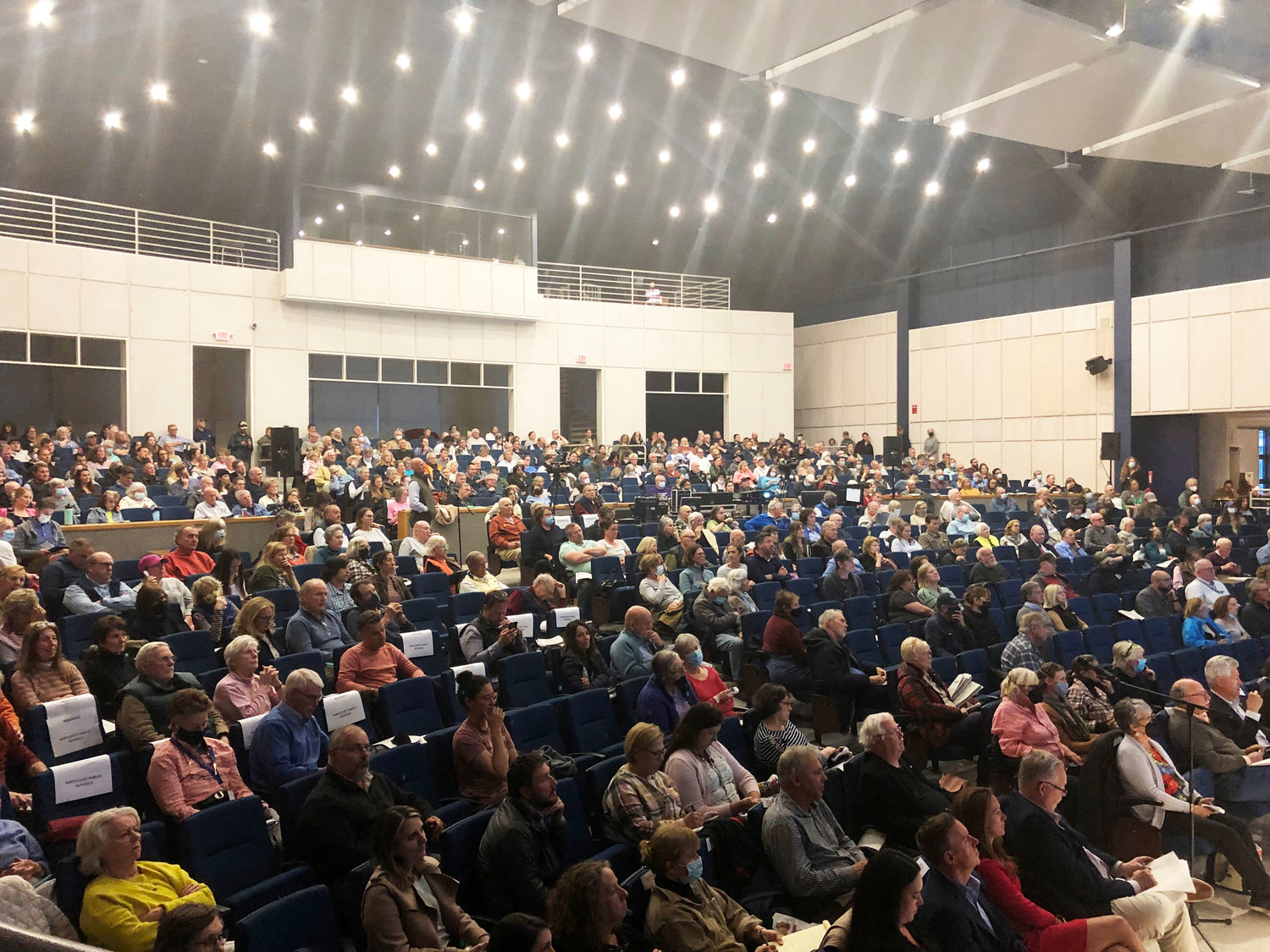 Town Meeting voters fill most of the seats in the Nantucket High School auditorium before voting on allowing anyone to go topless on island beaches Tuesday night.