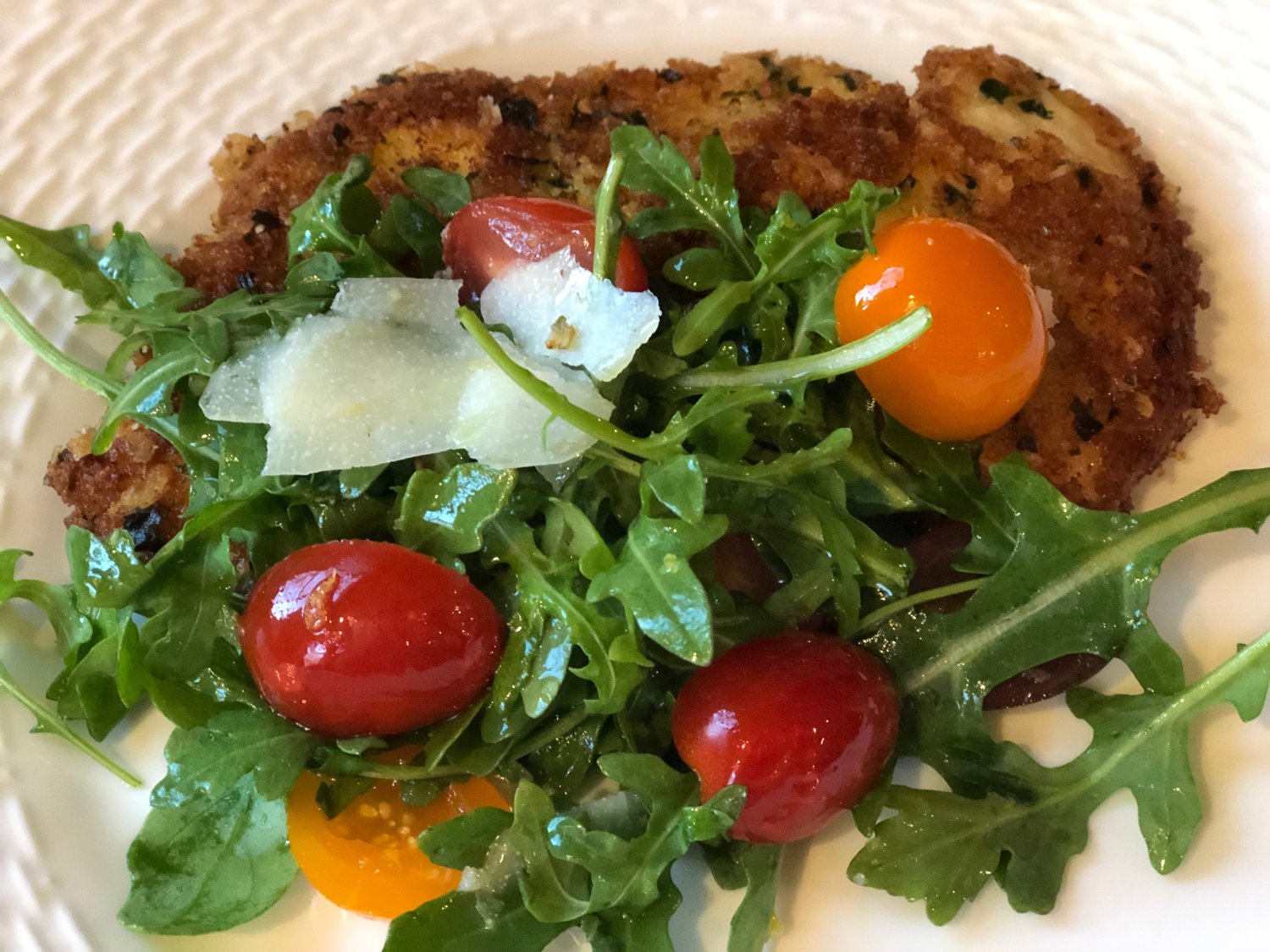 Anne Byrn’s Smashed Chicken Scallopine is lighter than a typical fried-chicken dish and has notes of spring with arugula and cherry tomatoes.