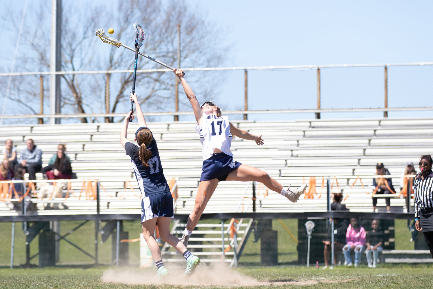 Bailey Lower soars above a Monomoy player on her way to grabbing a loose ball.