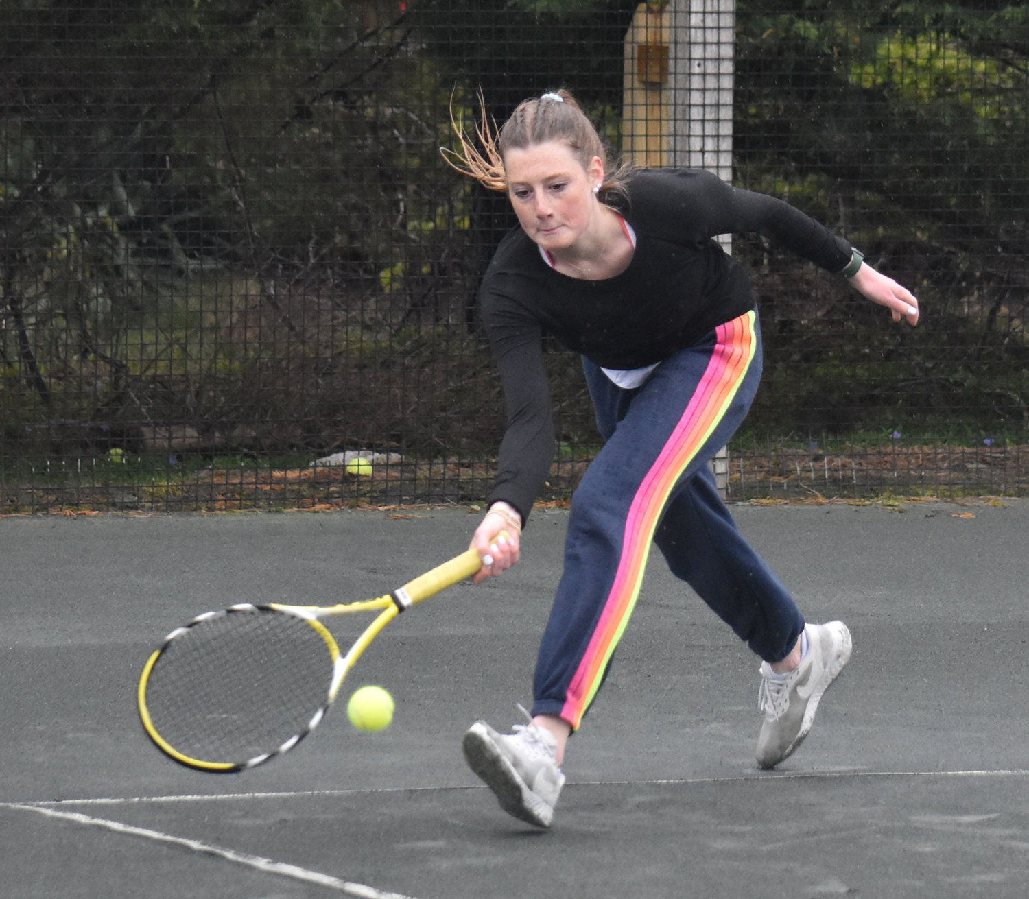 Emily Dussault reaches for a shot during Friday’s first singles match against Monomoy. The senior captain won in straight sets.