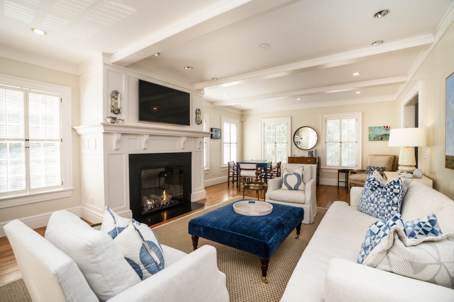 This living area has a fireplace, built-in cabinets and French-door access to the porch.