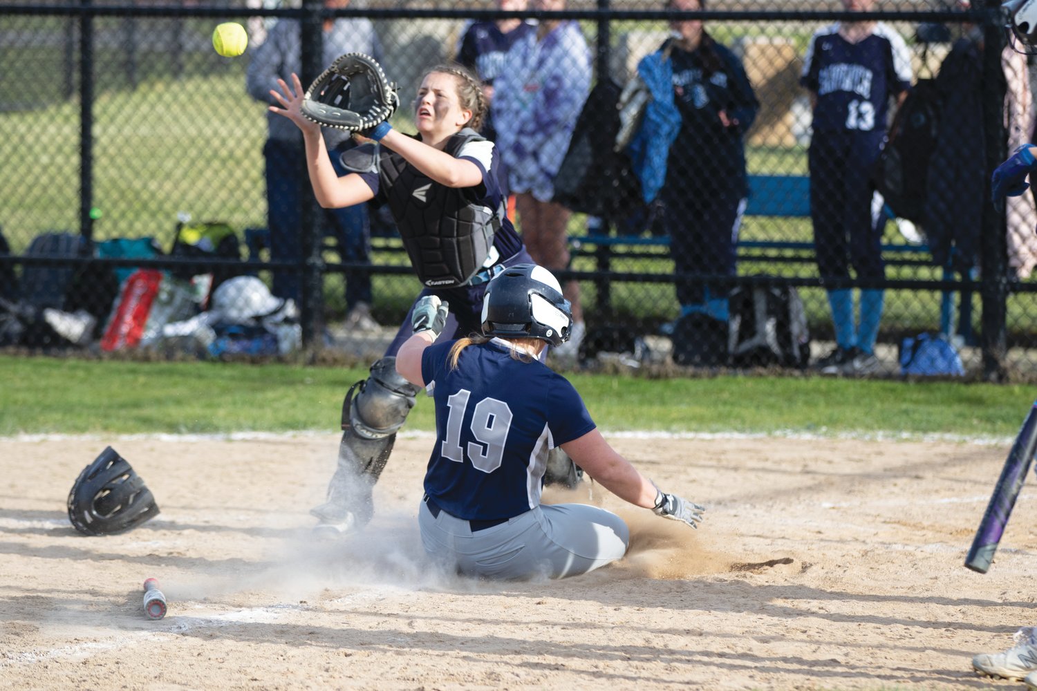 Melanie Bamber slides into home ahead of the throw.