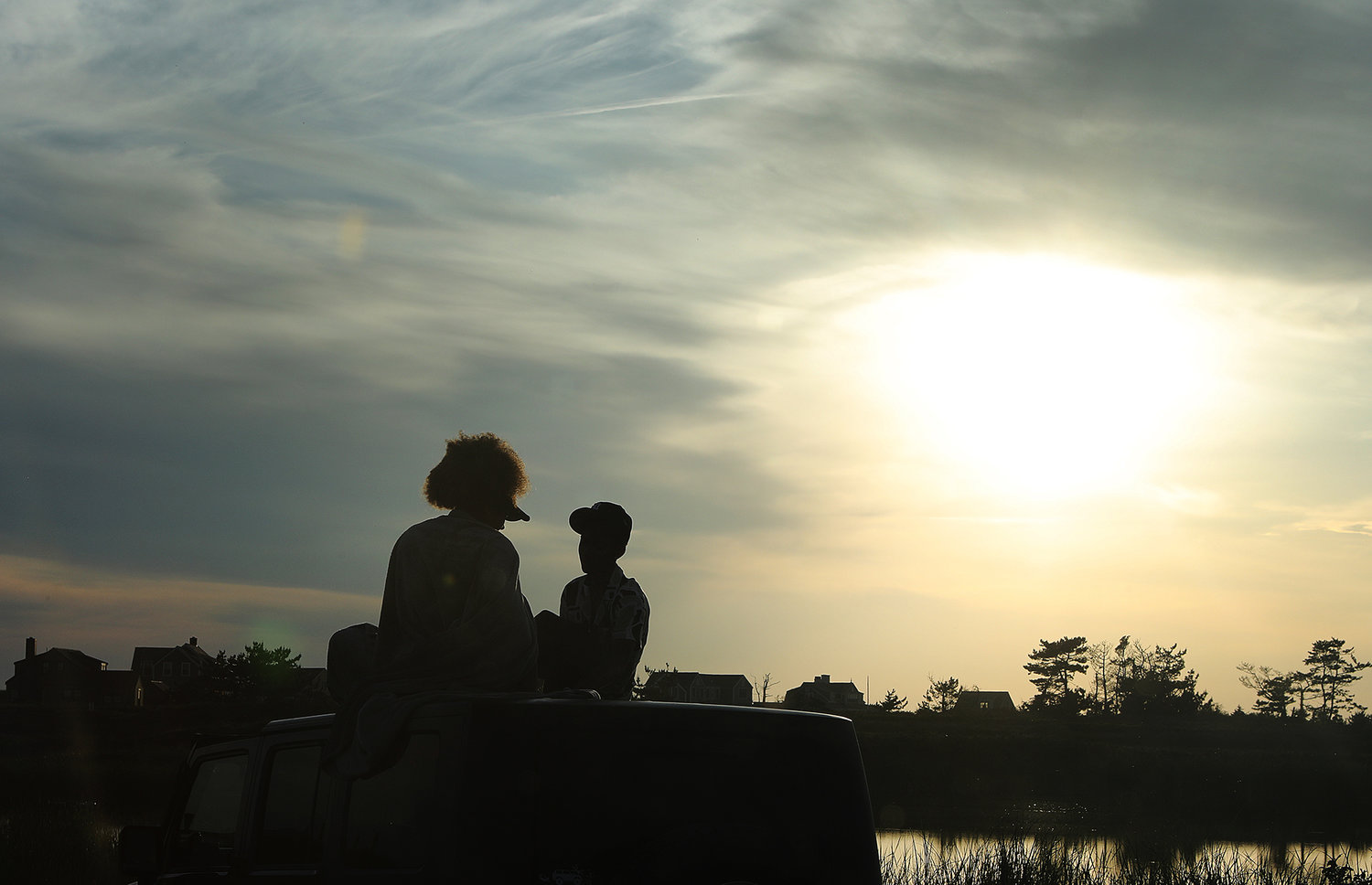 JUNE 6, 2022 -- People enjoy the sunset from the top of a Jeep at Miacomet Beach on Monday. Photo by Ray K. Saunders