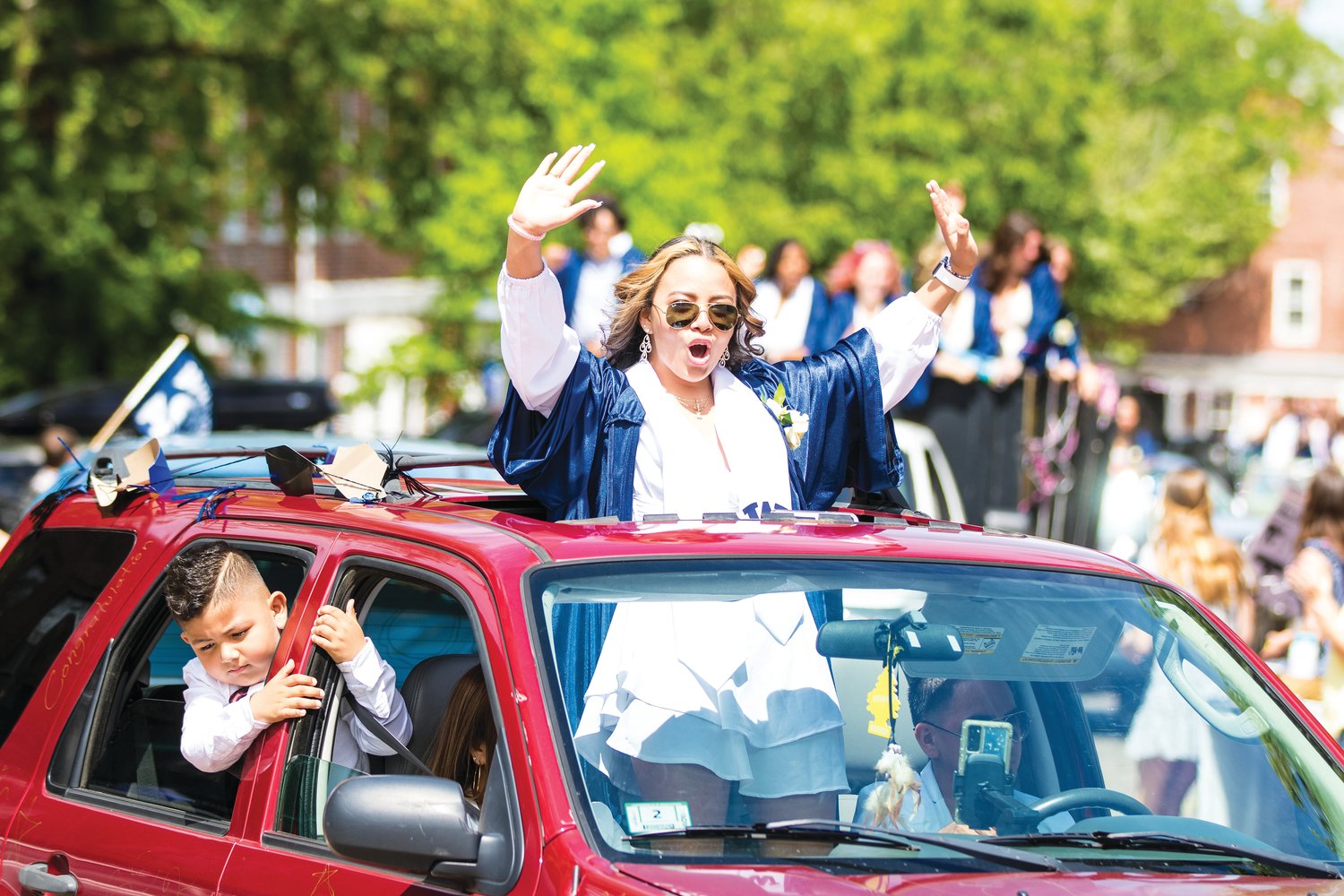 Johana Cerritos celebrates during the downtown car parade following Saturday’s graduation ceremony on the football field at Nantucket High School.
