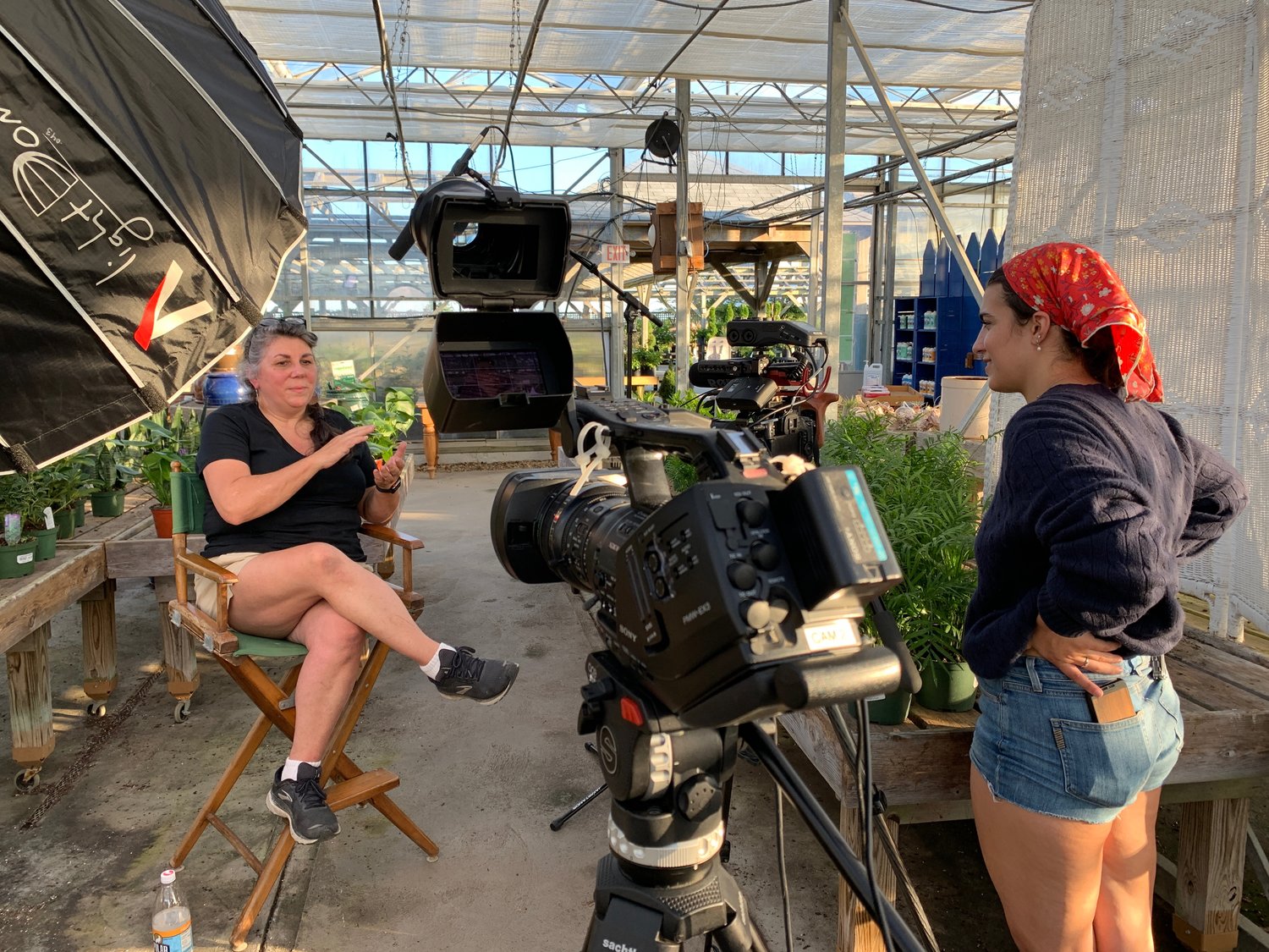 Grace Bartlett interviews MJ Mojer in a greenhouse at Bartlett’s Ocean View Farm.