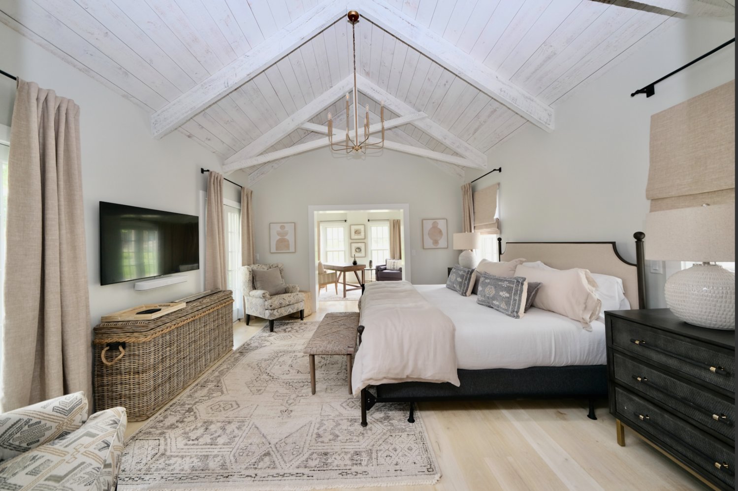 This bedroom suite has exposed beams and a sitting room.