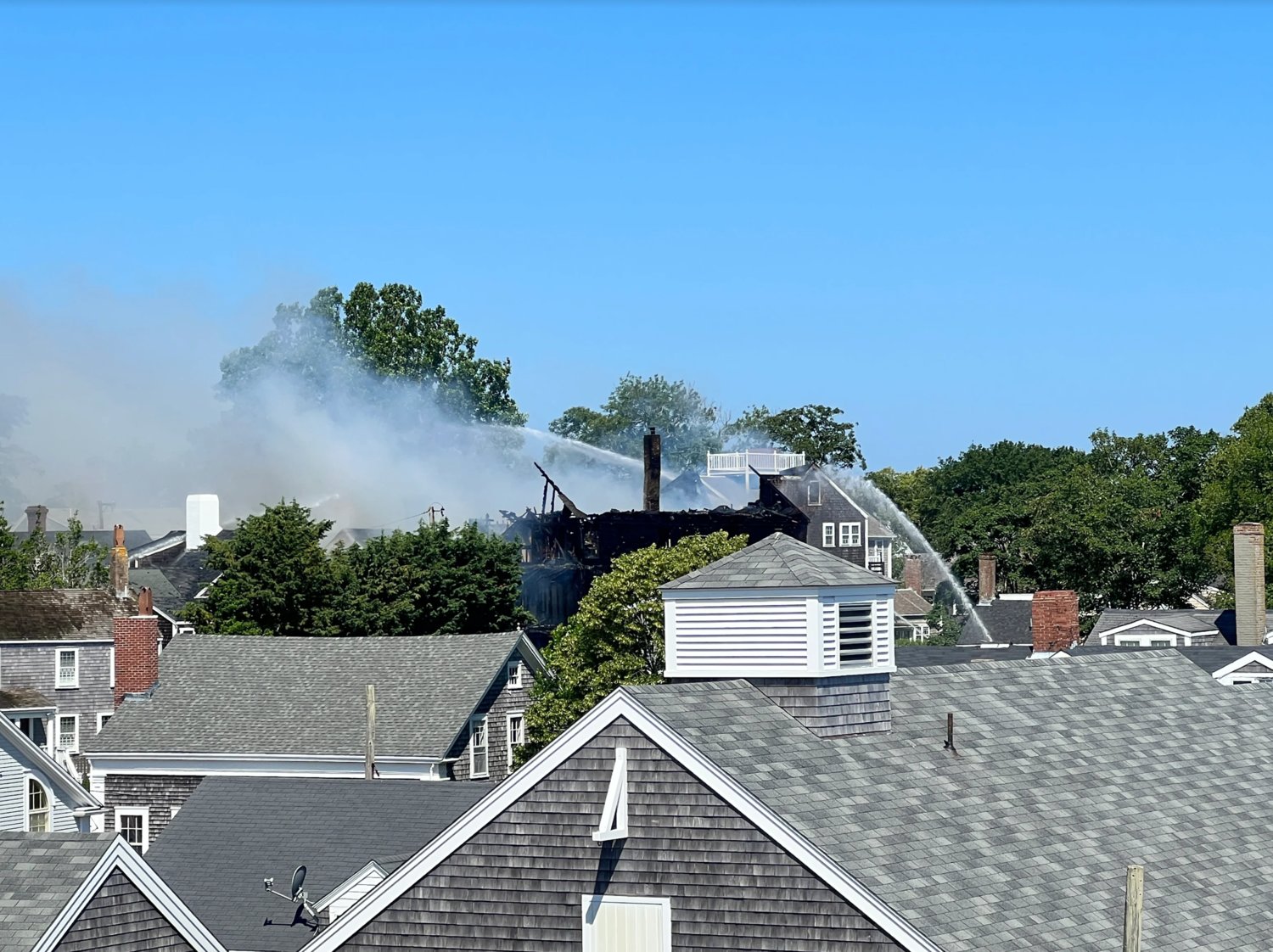 A view of the charred roof of the Veranda House from the roof deck of the Nantucket Whaling Museum.