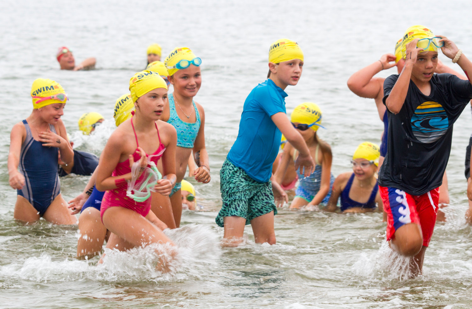 Young swimmers exit the water at Jetties Beach at a past Swim Across America-Nantucket.