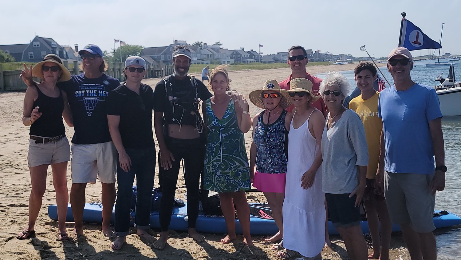 Adam Nagler, along with staff from Fairwinds and friends on the shore of Brant Point after his arrival.