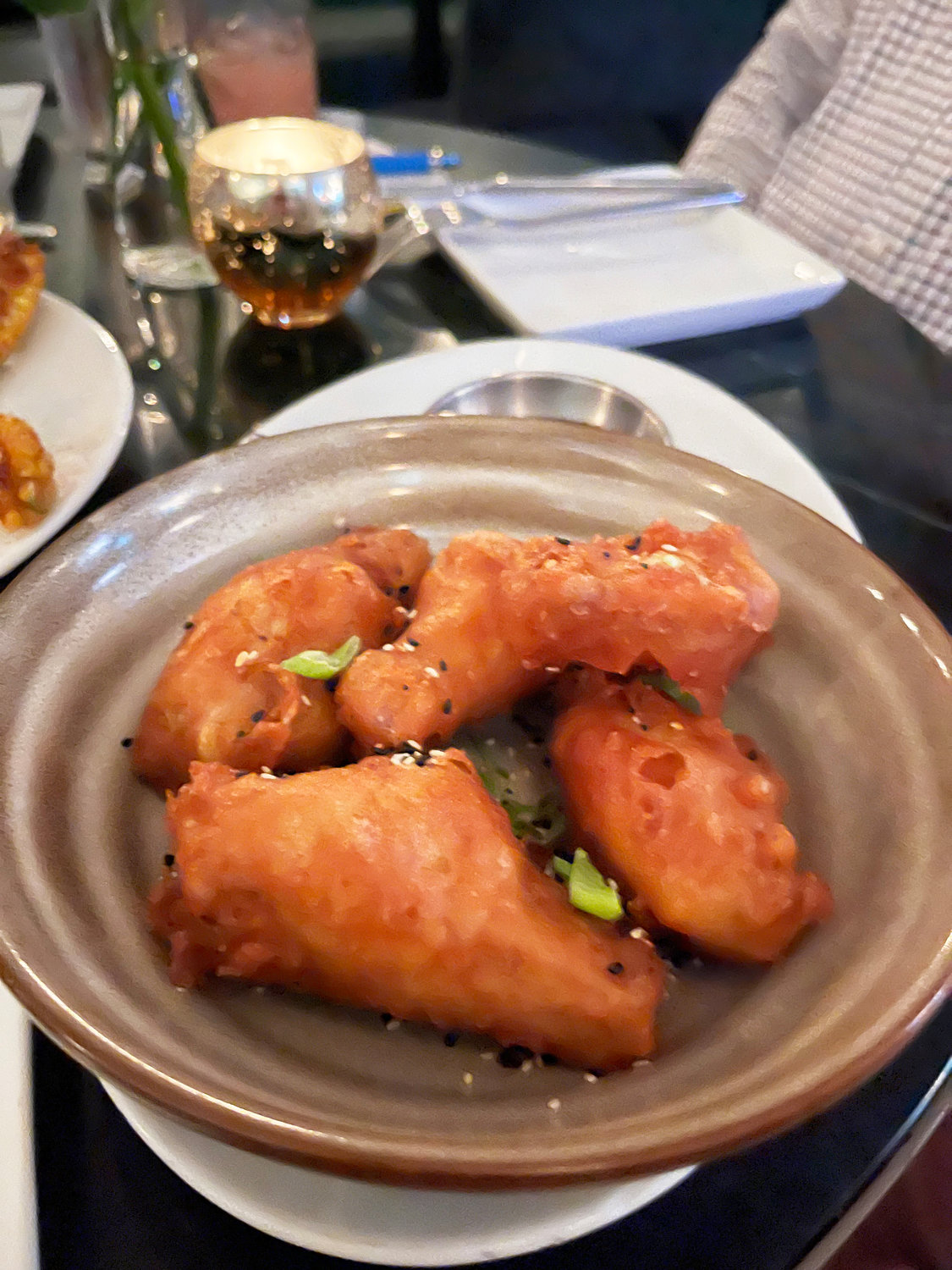 The chicken wings are coated in a light tempura batter and served with a Korean chili glaze.