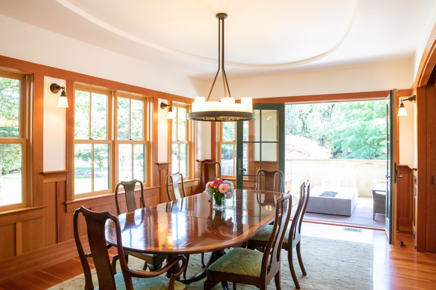 The dining room has multiple windows and access to the private porch with an electric fire pit.