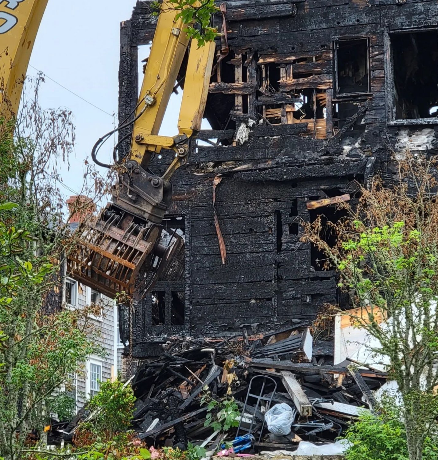 Demolition work on the Veranda House, destroyed by fire last month, began Monday morning.