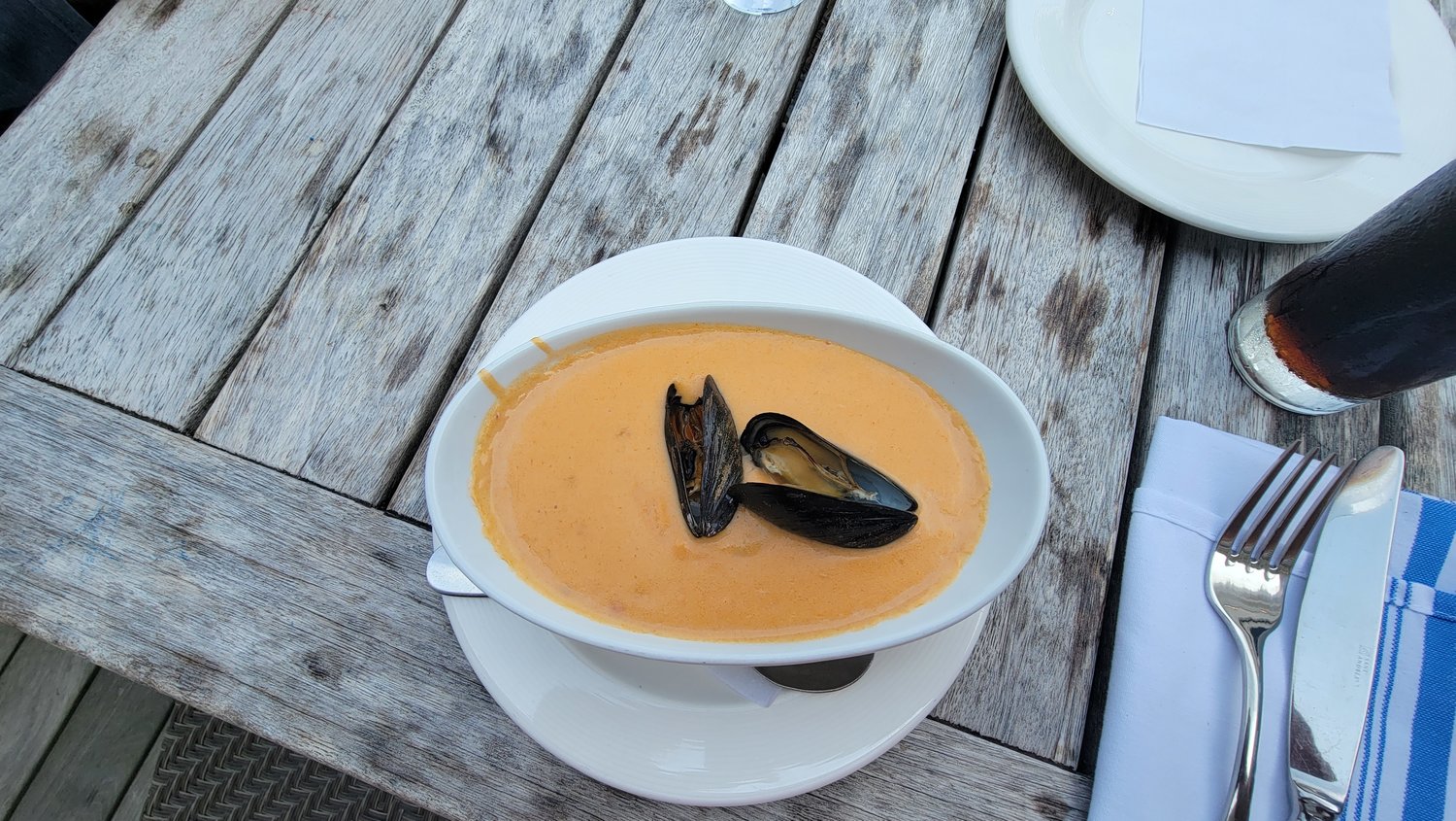 The lobster bisque is filled with chunks of lobster and topped with mussels.
