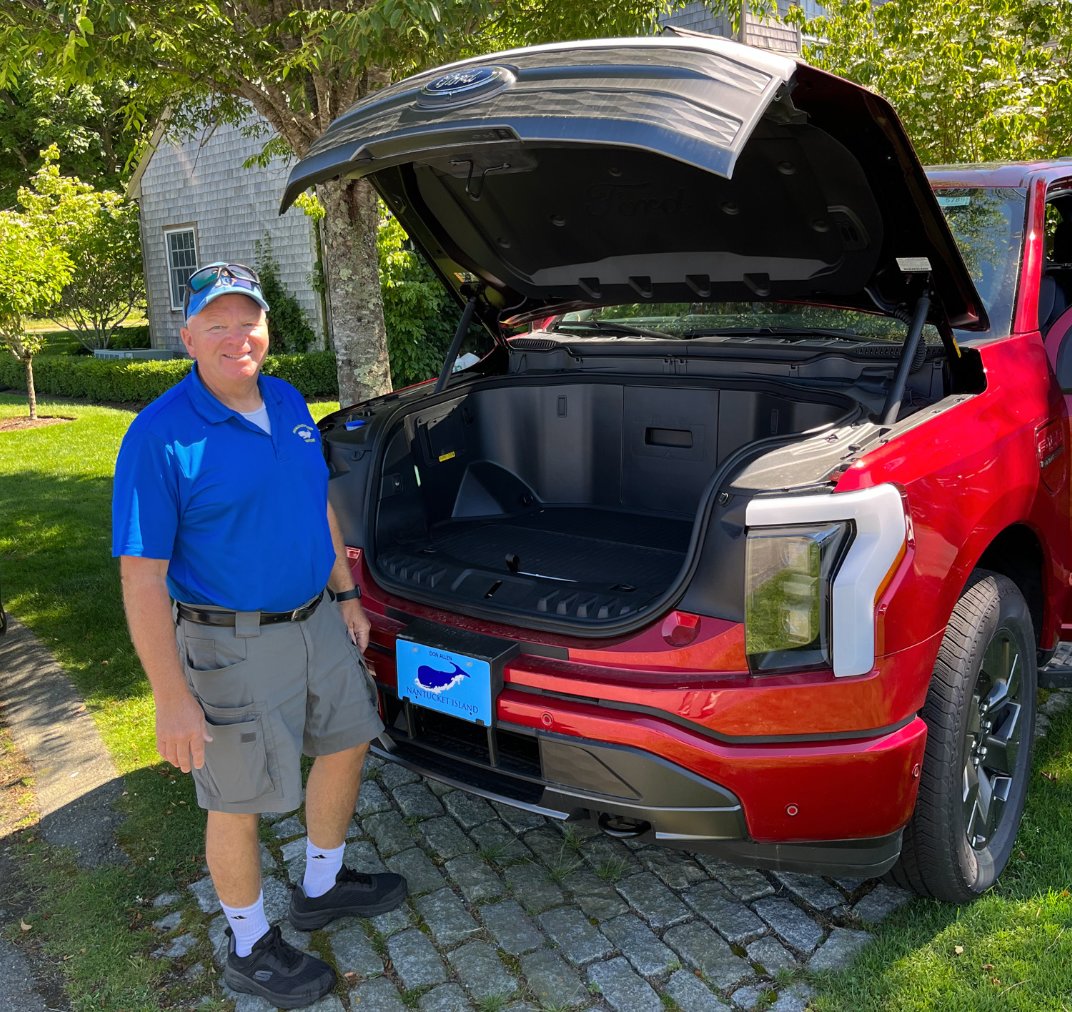 Bill Tornovish of Don Allen Ford with an electric F-150 Lightning pick-up truck.