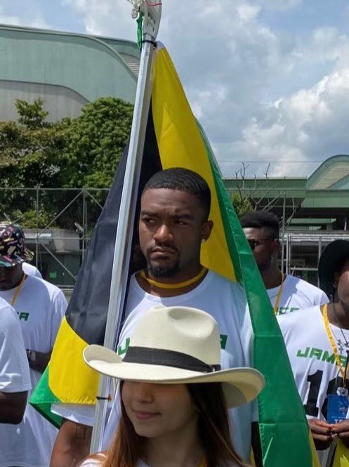 Matthew Marrett carries the Jamaican flag onto the field at a qualifying tournament in Colombia. The team has earned a spot in the 2023 World Lacrosse Championship.