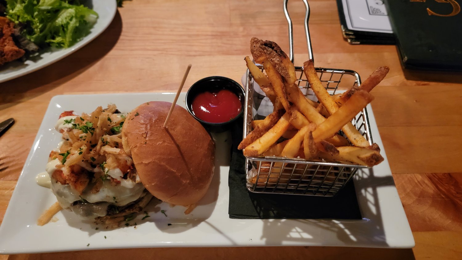The surf and turf burger is eight ounces of prime beef topped with lobster, Swiss cheese, onion straws and lemon aioli.
