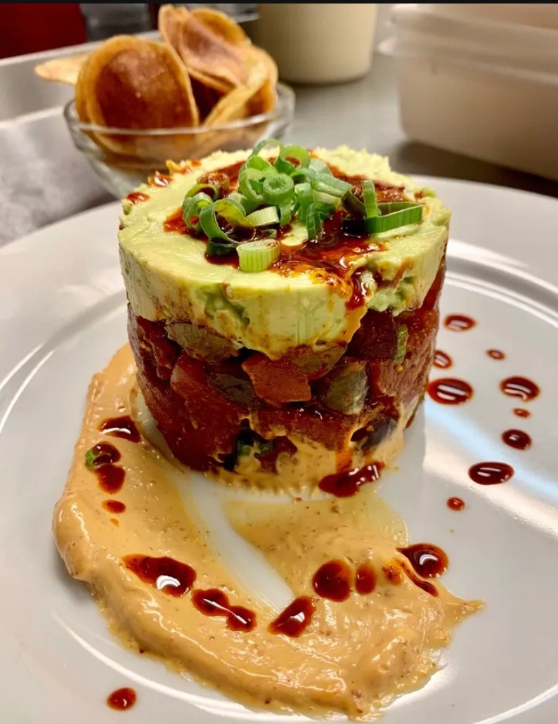 Petrichor’s tuna tartare is a delicious combination of tuna, avocado and grapes, topped with scallions, chili crisps and chili-crisp aioli.