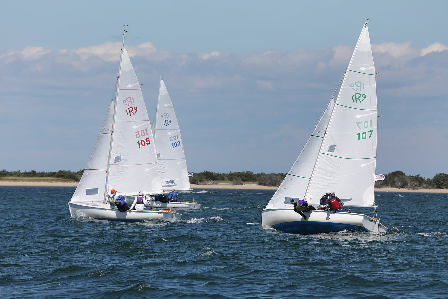Boats race during the Women's Regatta in the harbor on Thursday.
