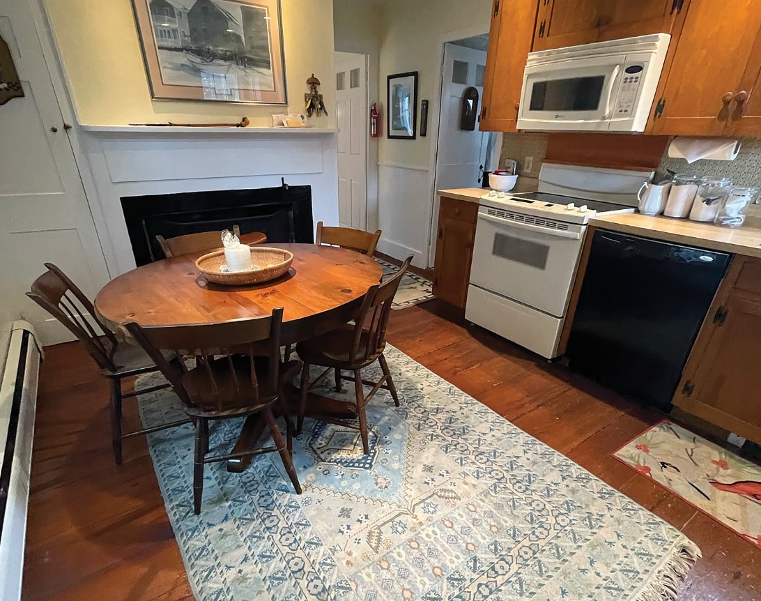 The eat-in kitchen of this historic Main Street home has wide pine floors and appliances by KitchenAid, Frigidaire and Whirlpool.