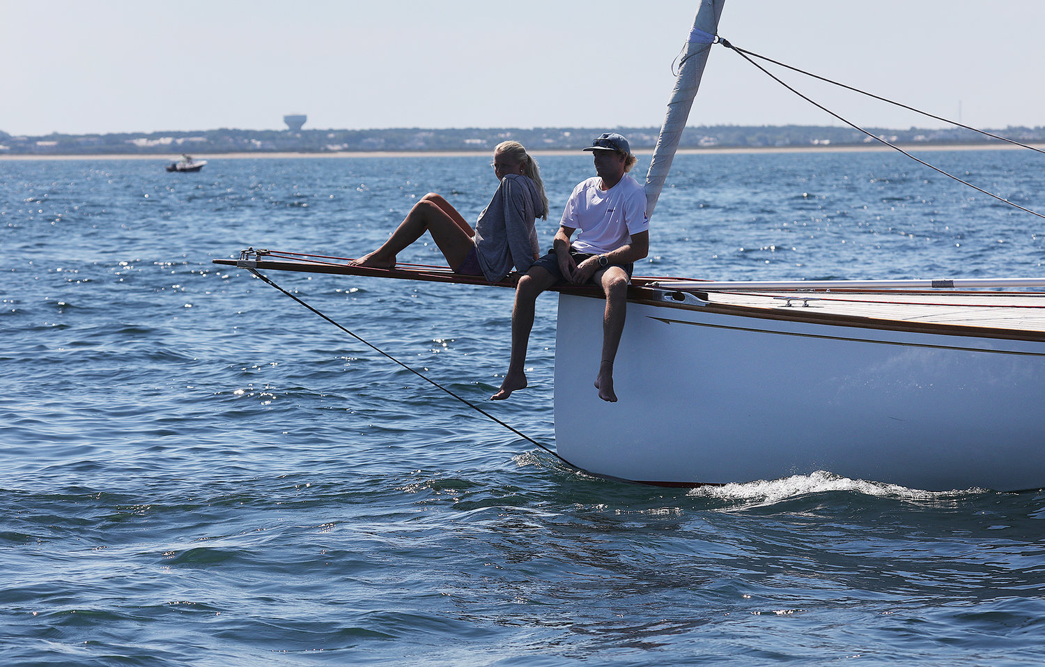 Crew members relax on the bow of the Cavalino, out of Newport, before competing in the Opera House Cup race on Sunday in Nantucket Sound.
