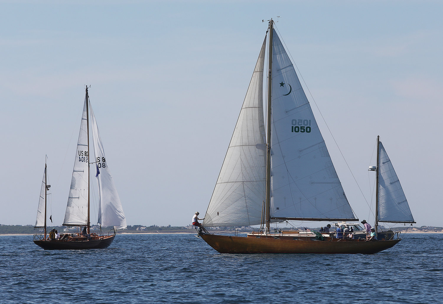 A crew member on the yawl Katrina sets the jib at the start of the Opera House Cup race on Sunday in Nantucket Sound.