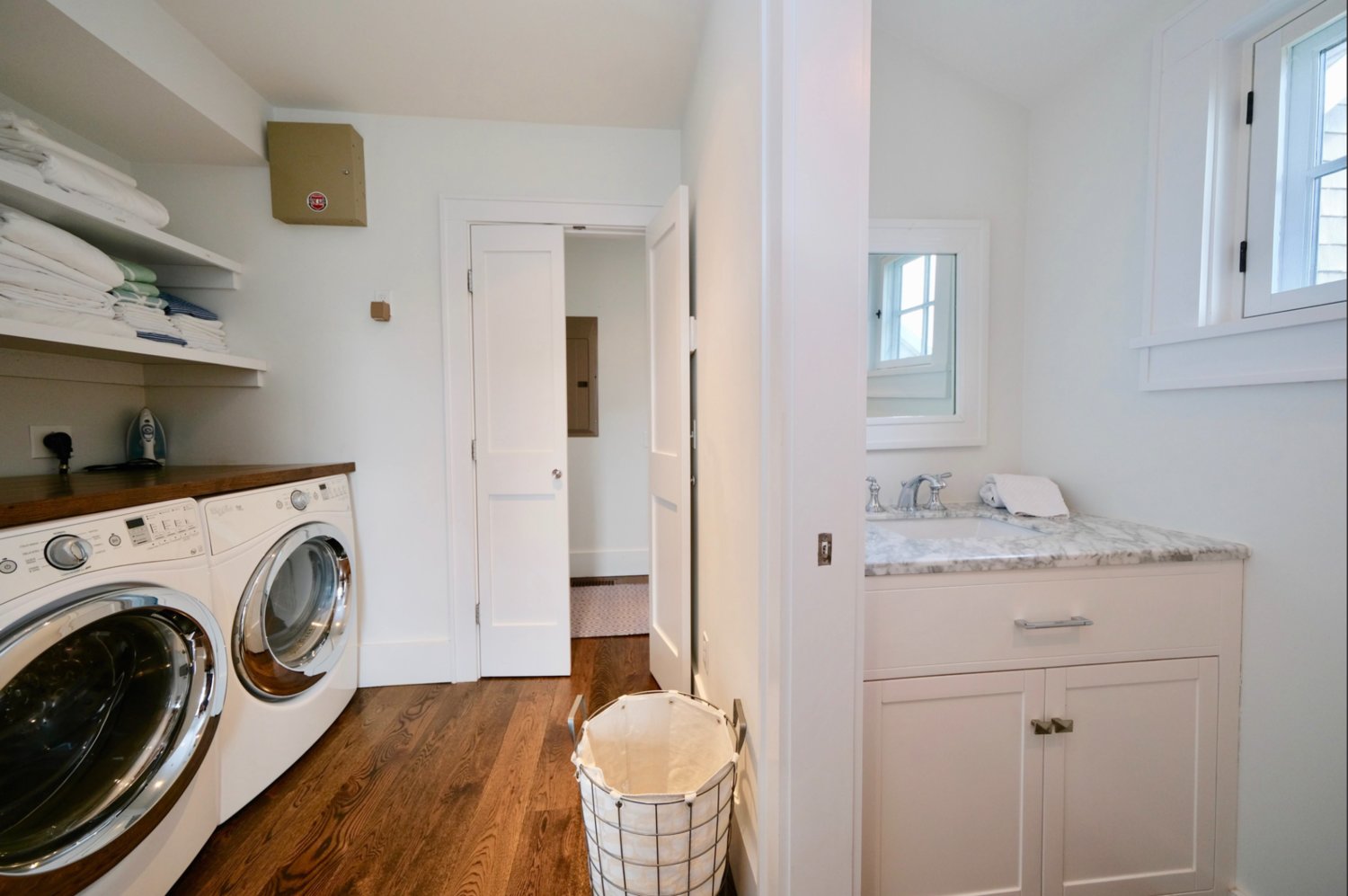 The laundry room has a side-by-side washer and dryer and storage space.