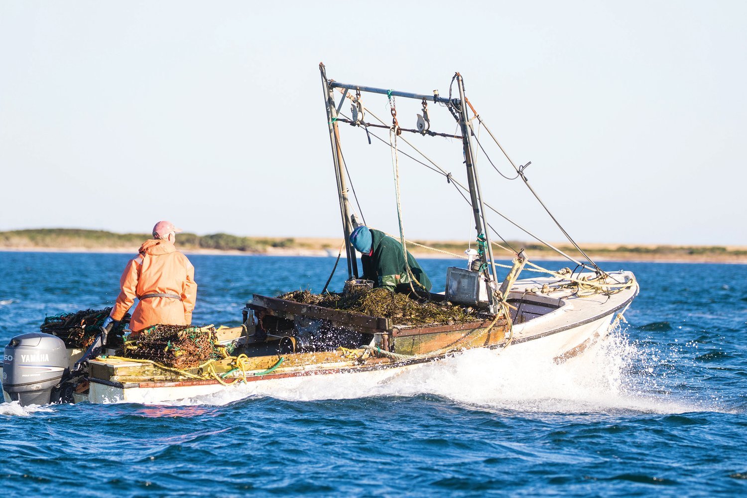 A scalloper heads out onto Nantucket Harbor on the opening day of the commercial season last November.
