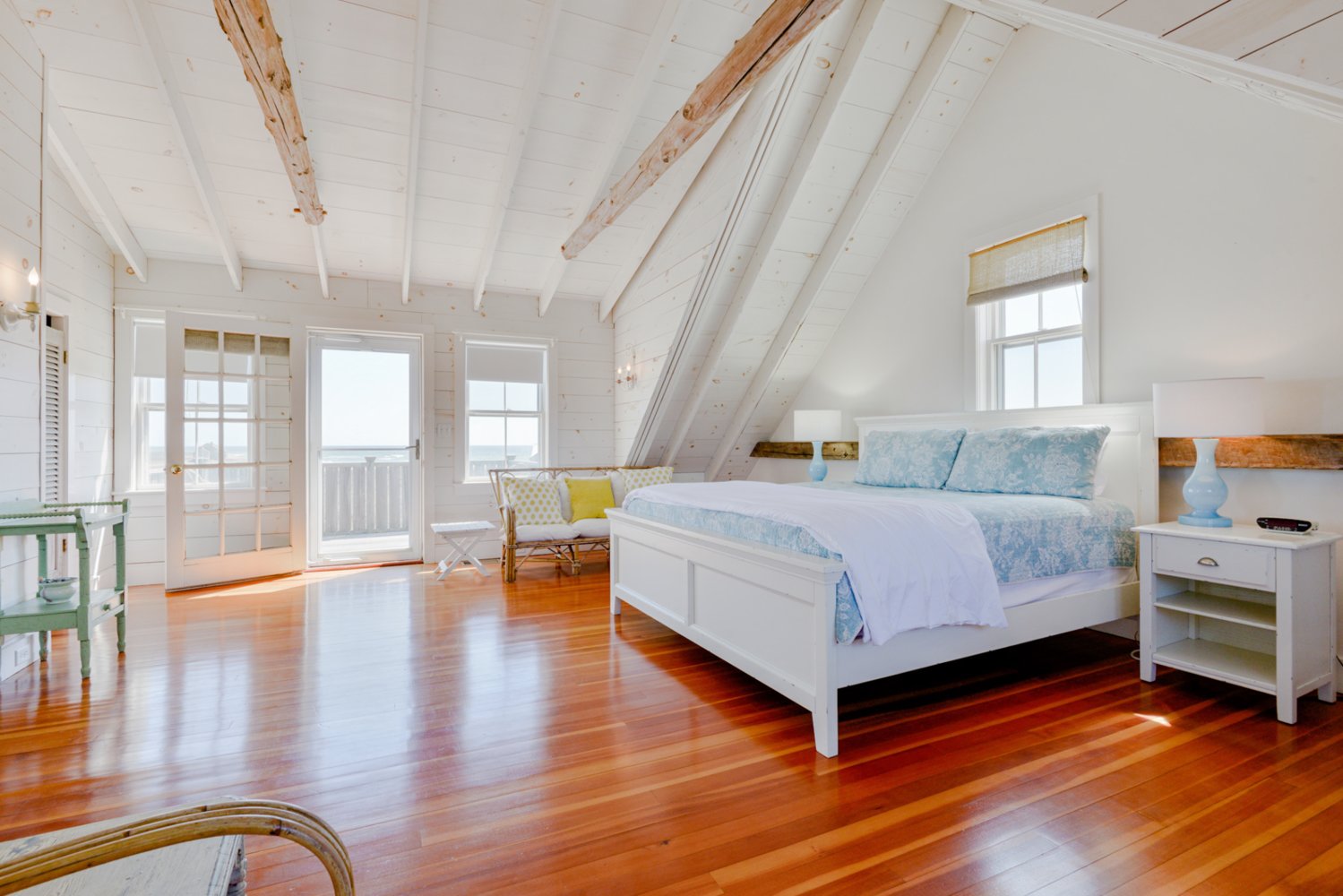 The second-floor master bedroom has a vaulted ceiling and a private deck.