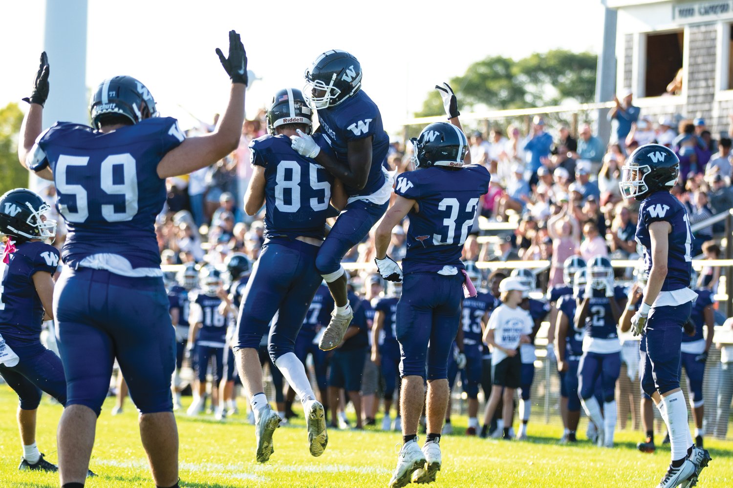 The Whalers celebrate a second-half touchdown run in front of a packed house Saturday in the football team’s home opener, a 29-28 loss to Mashpee.