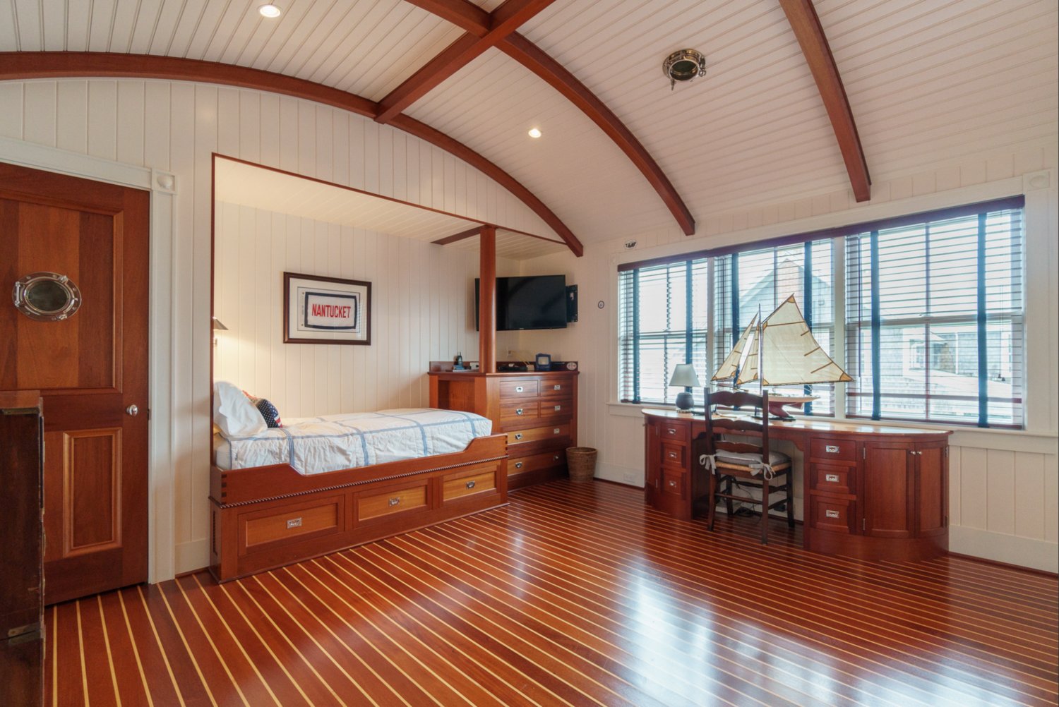 This nautically-inspired bedroom has a barrel ceiling.