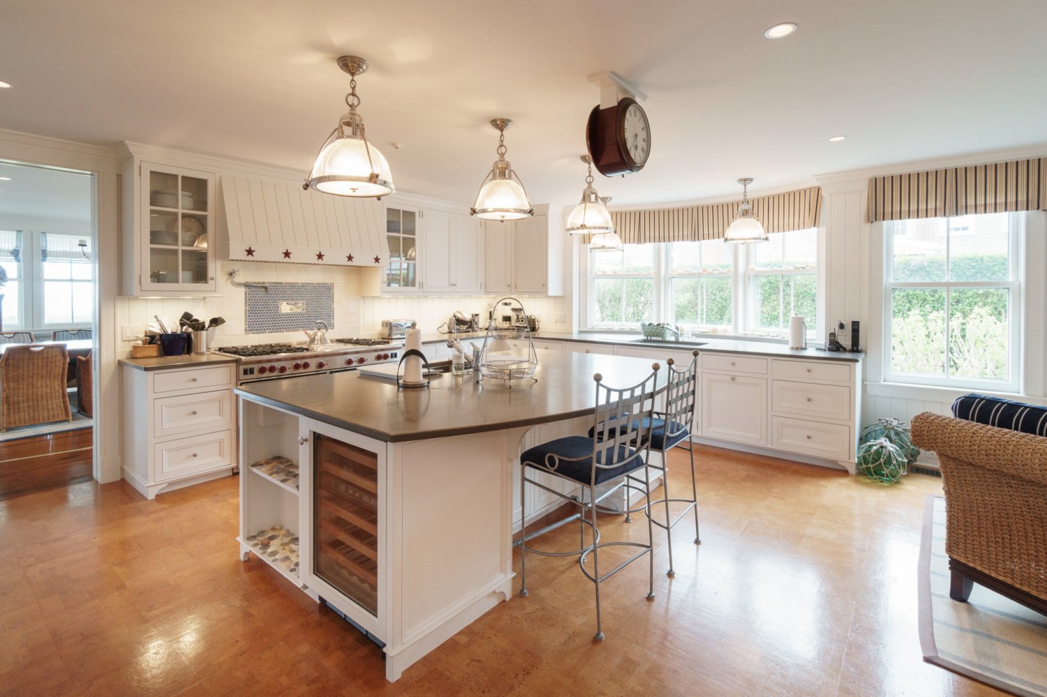 The spacious gourmet kitchen has high-end appliances including a six-burner Wolf gas range with a griddle and two ovens, and two Sub-Zero refrigerators.