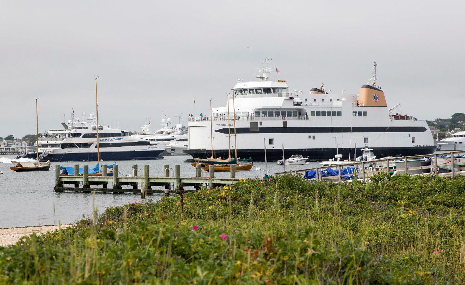 The Steamship Authority car ferry Woods Hole and fast ferry Iyanough pass in Nantucket Harbor.