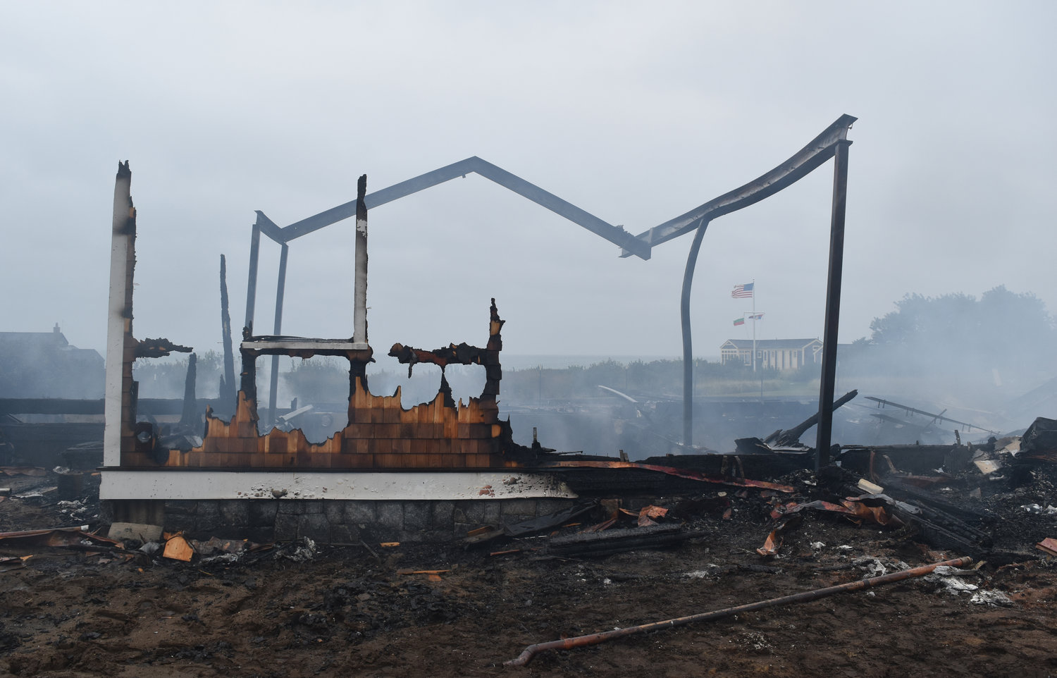 The remnants of the East Tristram Avenue home after it was destroyed by fire early Saturday morning. Owner Richard Phillips was staying in the beach house visible in the background during construction of the home.