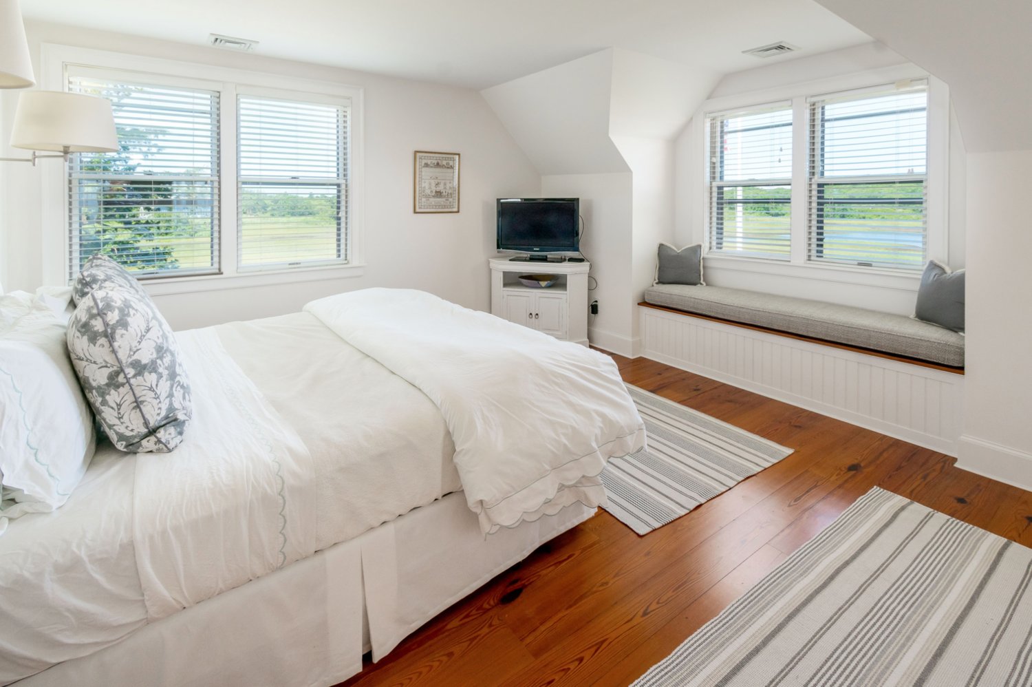This bedroom has a window seat with sweeping views of Polpis Harbor.