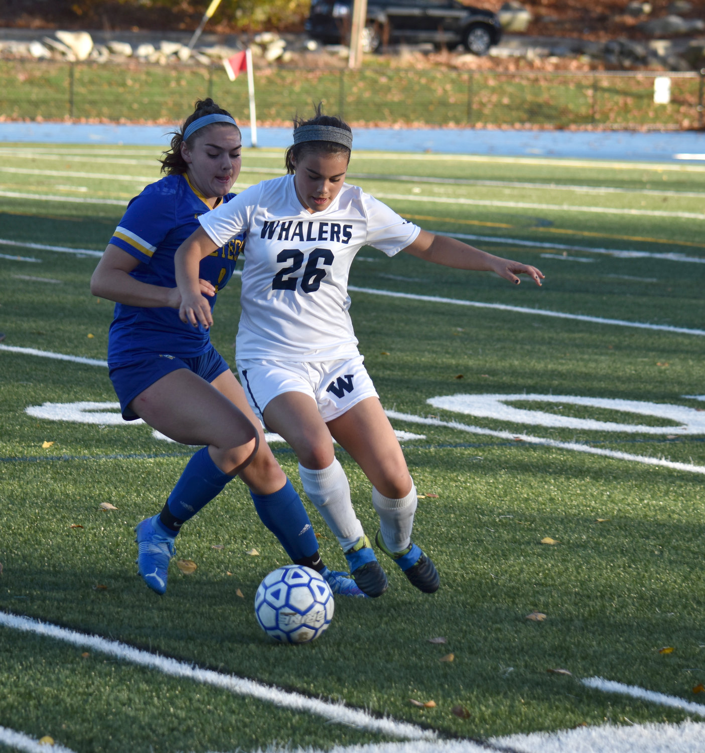 Taylor Bistany knocks the ball away from an Assabet Valley player.