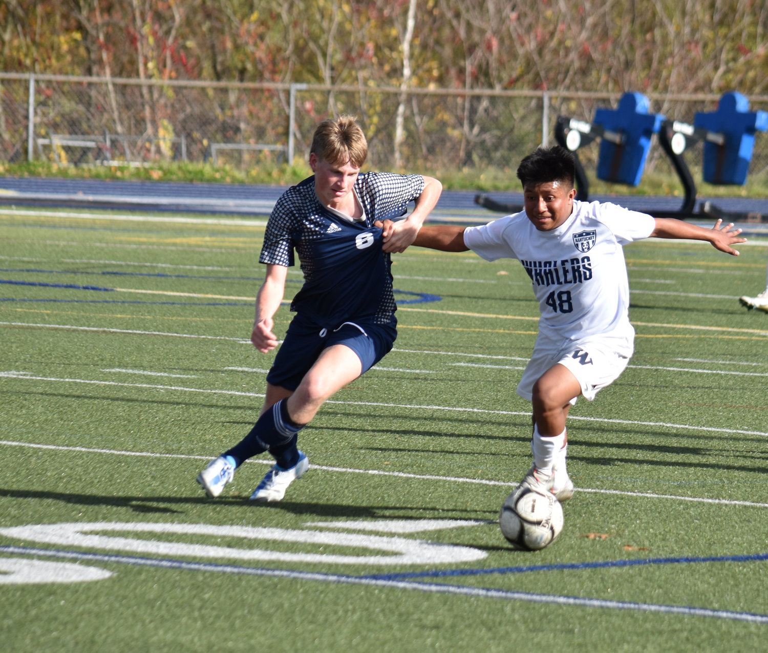Ericson Yonilson and a Cohasset player jockey for possession.